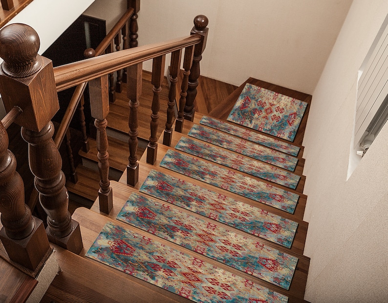 May include: A set of 7 stair treads with a colorful, abstract pattern in shades of blue, red, and beige. The treads are made of a soft, non-slip material and are perfect for adding a touch of style to any staircase.