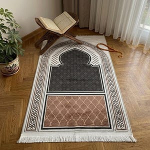 a prayer mat with a wooden stand, a potted plant, and a book on a wooden stand, all placed on a wooden floor.