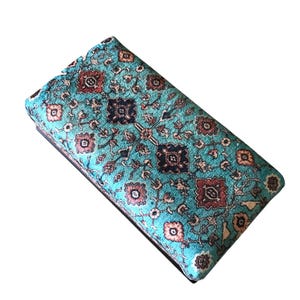A colorful, patterned wallet or card case with a turquoise and brown color scheme, featuring intricate floral and geometric designs.