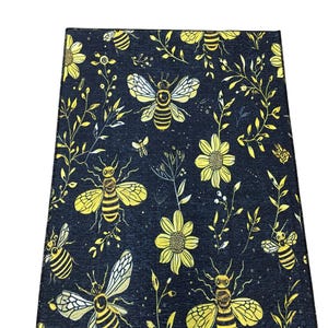 a black and yellow floral pattern with bees and flowers.