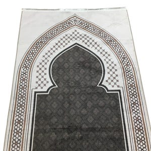 a decorative prayer mat with an intricate geometric pattern and an arched design.