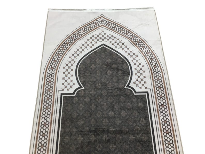 a decorative prayer mat with an intricate geometric pattern and an arched design.