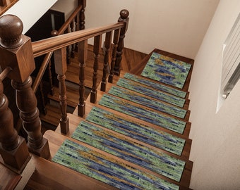 May include: A set of six stair treads with a blue, green and gold abstract pattern. The treads are placed on a wooden staircase.