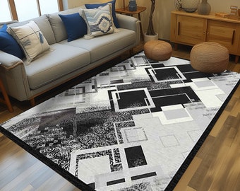 May include: A black and white geometric area rug with a modern design. The rug has a black border and is laid out on a hardwood floor in a living room setting.
