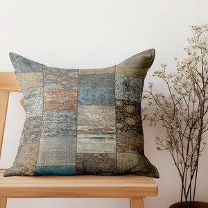 May include: A decorative throw pillow with a patchwork design featuring various shades of blue, brown, and beige. The pillow is sitting on a wooden chair.