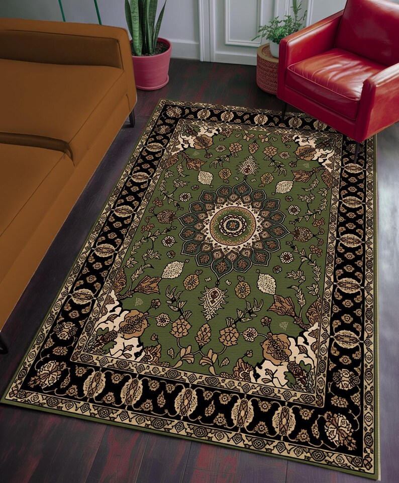 a large, ornate rug with a floral design on a wooden floor. The rug is surrounded by a brown couch and a red chair, creating a cozy and inviting living space.