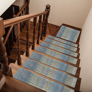 May include: A set of blue and yellow patterned stair treads. The treads are made of a soft, non-slip material and are designed to add a touch of style and safety to any staircase.