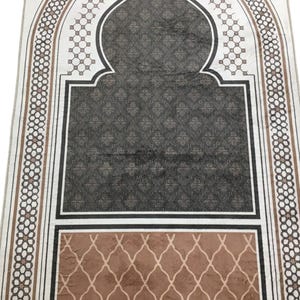 a decorative rug with a geometric pattern in shades of brown and black.
