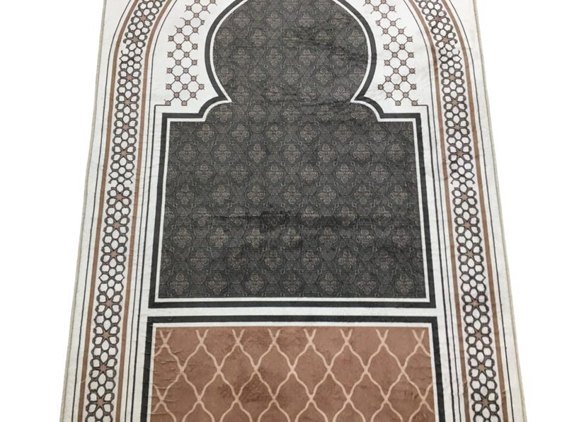 a decorative rug with a geometric pattern in shades of brown and black.