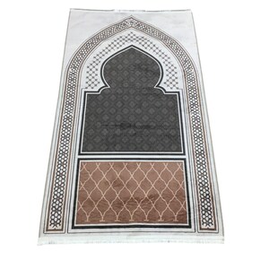 a decorative prayer mat with an intricate design and a geometric pattern.