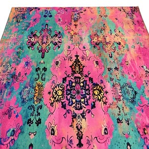 a vibrant, colorful rug with intricate patterns and designs in shades of pink, blue, green, and yellow.