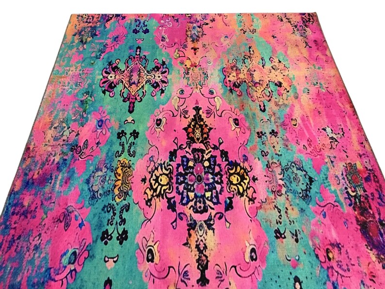 a vibrant, colorful rug with intricate patterns and designs in shades of pink, blue, green, and yellow.