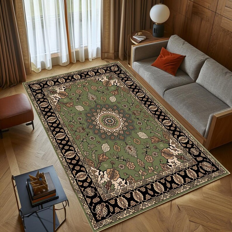 a cozy living room with a large, ornate rug on the floor, a gray sofa, and a wooden coffee table. The room has a warm and inviting atmosphere, with natural light coming in through the window and a lamp providing additional lighting.