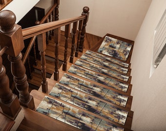 May include: A set of six non-slip stair treads with an abstract design in shades of brown, blue, and purple. The treads are placed on a wooden staircase.