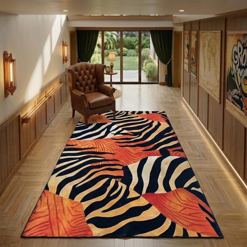 a hallway with a large rug featuring a zebra print design in black, white, and orange colors. The rug is placed on a wooden floor, and there is a leather armchair in the background. The hallway also has a sliding glass door and wooden paneling on the walls.