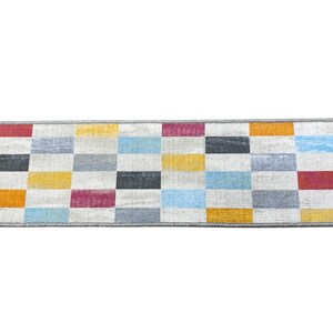 a rectangular rug with a geometric pattern of squares in various colors, including red, orange, yellow, green, blue, gray, and white.