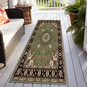 a rug on a porch with a white bench, a wicker chair, and a potted plant.