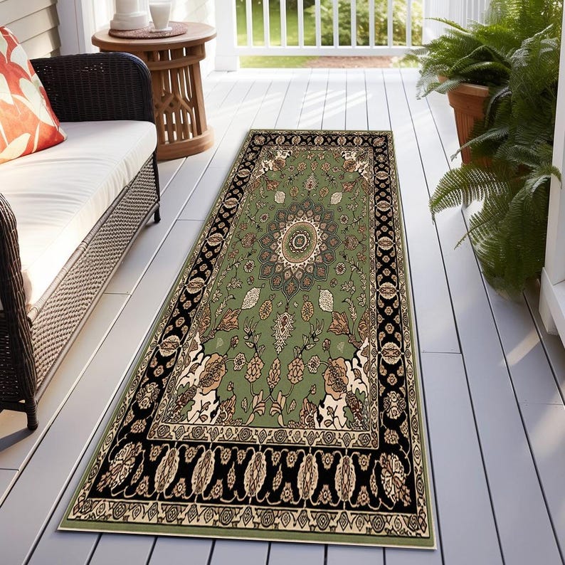 a rug on a porch with a white bench, a wicker chair, and a potted plant.
