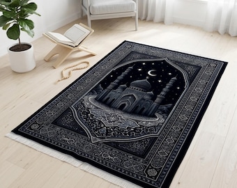 May include: A black prayer rug featuring a mosque design with a night sky backdrop, stars, and a crescent moon. The rug has a detailed border and fringe.