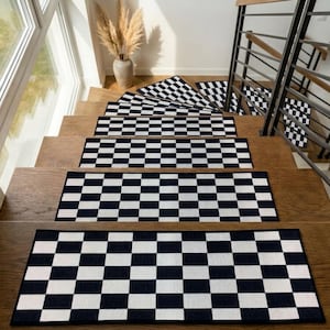 May include: A set of rectangular stair treads featuring a high-contrast black and white checkered pattern. Each individual tread is positioned centrally on a wooden step, creating a repeating geometric design that spans the length of the staircase.