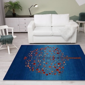 May include: A blue and red area rug with a stylized tree design. The tree has a brown trunk and branches with red leaves. The rug has a gradient design with a darker blue color at the bottom and a lighter blue color at the top.