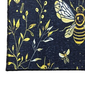a close-up view of a black and yellow floral pattern with a bee design.