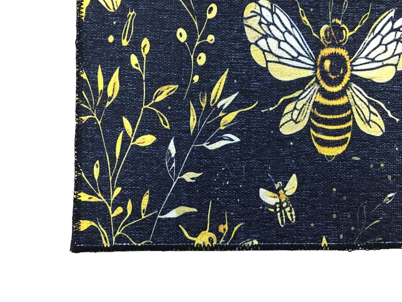 a close-up view of a black and yellow floral pattern with a bee design.