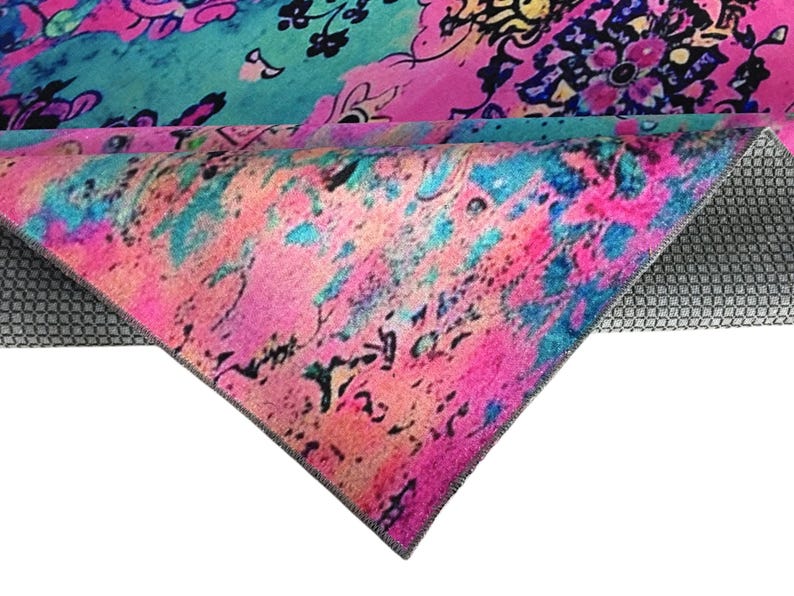 a vibrant, multicolored fabric with a floral pattern. The fabric appears to be a rug or textile with a bold, abstract design.