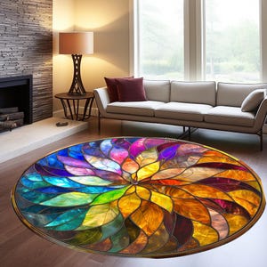 May include: A round, colorful rug with a stained glass design. The rug features a circular pattern of overlapping, multi-colored leaves, creating a kaleidoscope effect. The colors include shades of blue, green, yellow, orange, red, and purple.