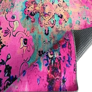 a vibrant, colorful, and abstract pattern with various shades of pink, blue, and green. The pattern appears to be a textile or fabric design, with a mix of organic and geometric shapes and patterns. The image does not contain any text or specific objects, and the focus is on the visual elements and the overall composition of the design.