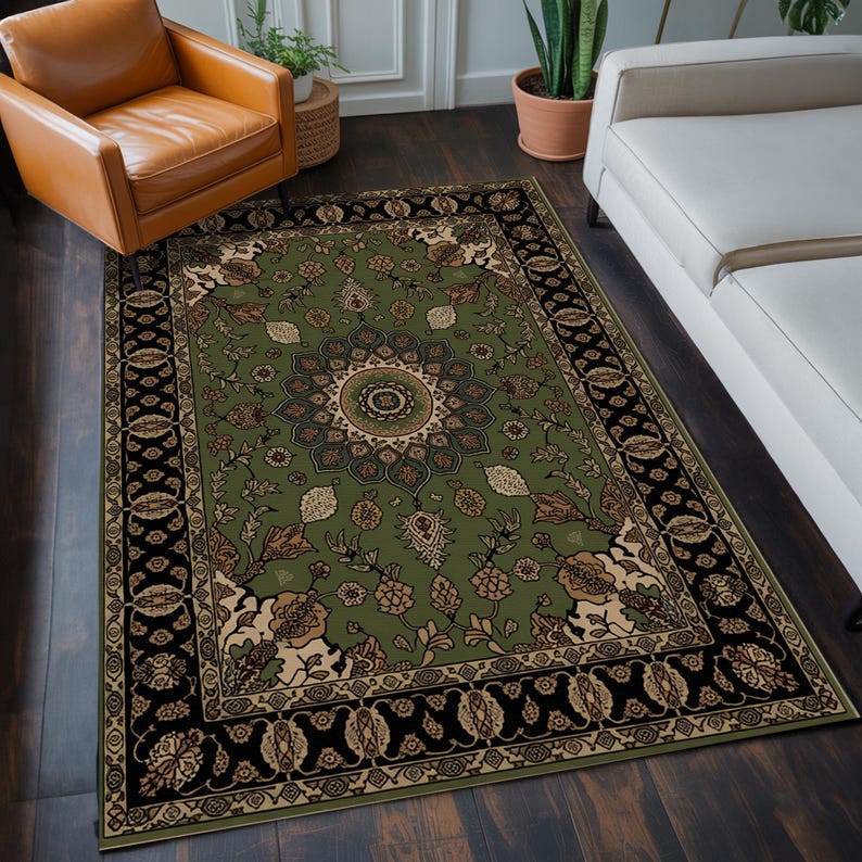 a large, ornate rug with a floral design on a wooden floor. The rug is surrounded by a leather chair and a white couch, creating a cozy and inviting living space.