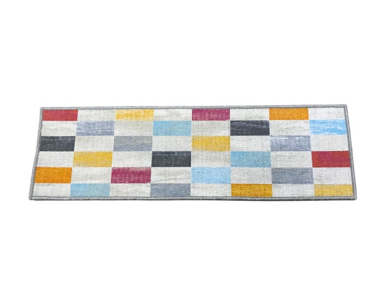 a rectangular rug with a geometric pattern of squares in various colors, including red, orange, yellow, green, blue, gray, and white.