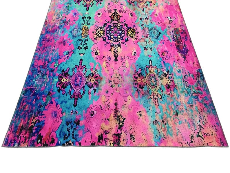 a vibrant, colorful rug with intricate patterns and designs in shades of pink, blue, and green.