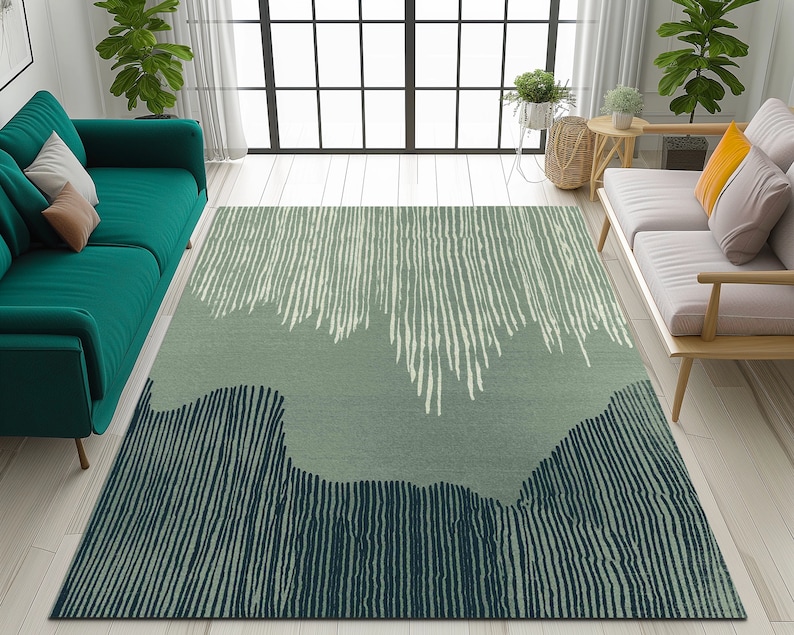 May include: A green and blue abstract area rug with a striped pattern. The rug has a light green background with white and dark blue stripes.