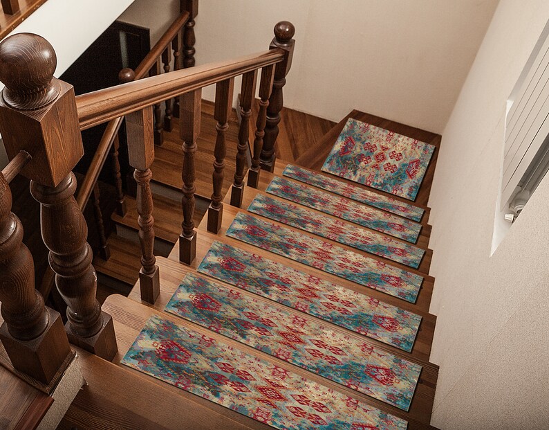 May include: A set of 7 stair treads with a colorful, abstract pattern in shades of blue, red, and beige. The treads are made of a soft, non-slip material and are perfect for adding a touch of style to any staircase.