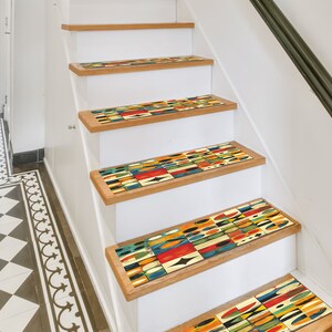May include: A set of colourful geometric patterned non-slip stair treads. The treads are made of a durable material and are designed to help prevent slips and falls on stairs.