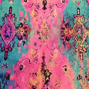 The image is a vibrant and colorful abstract pattern, featuring a mix of pink, blue, yellow, and green hues. The pattern is composed of various shapes and designs, creating a visually striking and dynamic composition.