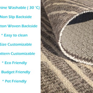 May include: A close-up of a rug with a gray and white striped pattern. The rug has a non-slip cotton woven backside. The rug is machine washable at 30 degrees Celsius. The rug is also eco-friendly, budget-friendly, and pet-friendly.