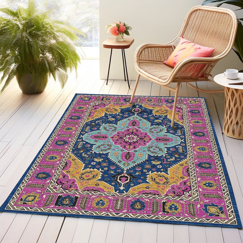 May include: A colorful rug with a geometric pattern in shades of pink, blue, yellow, and white. The rug has a traditional Persian design with intricate details.