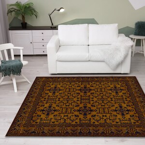 May include: A brown and blue patterned area rug with a geometric design. The rug is in a living room setting with a white couch and a white chair.