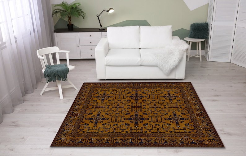 May include: A brown and blue patterned area rug with a geometric design. The rug is in a living room setting with a white couch and a white chair.