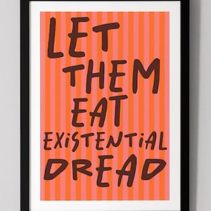 Puede incluir: Una impresión artística enmarcada con el texto "LET THEM EAT EXISTENTIAL DREAD" en letras marrón oscuro. El fondo presenta rayas verticales en tonos naranja y rosa. El marco es negro.