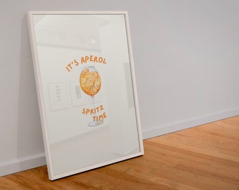 May include: White framed print with a watercolor illustration of an Aperol Spritz cocktail. The text "It's Aperol Spritz Time" is written in orange.