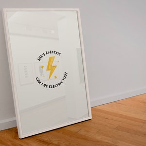 May include: A white framed mirror with a yellow lightning bolt graphic and the text "She's Electric Can I Be Electric Too?"