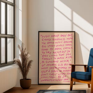 May include: A framed wall art print with a light peach background and dark pink handwritten text that reads: WHAT WOULD DOLLY DO?, CHOOSE KINDNESS. WEAR THE DAMN OUTFIT. DREAM BIG. LAUGH LOUDLY. WORK HARD. BE BRAVE ENOUGH TO TRY. NEVER GET SO BUSY.