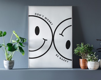 May include: A white framed poster with two black and white smiley faces. The text on the poster reads "Don't Worry Be Happy". The poster is hanging on a gray wall above a shelf with four potted plants.