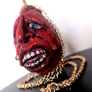Behelit pendant from Berserk manga