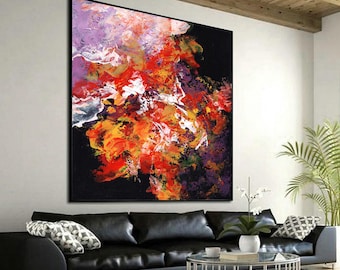 May include: A large square abstract painting featuring a bold explosion of vibrant red, orange, yellow, and purple paint strokes set against a deep black background, displayed as a prominent wall art piece in a contemporary living space.