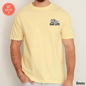 a man with a beard wearing a yellow shirt