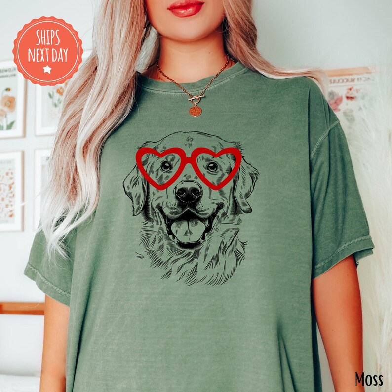 a woman wearing a green shirt with a dog wearing heart shaped glasses